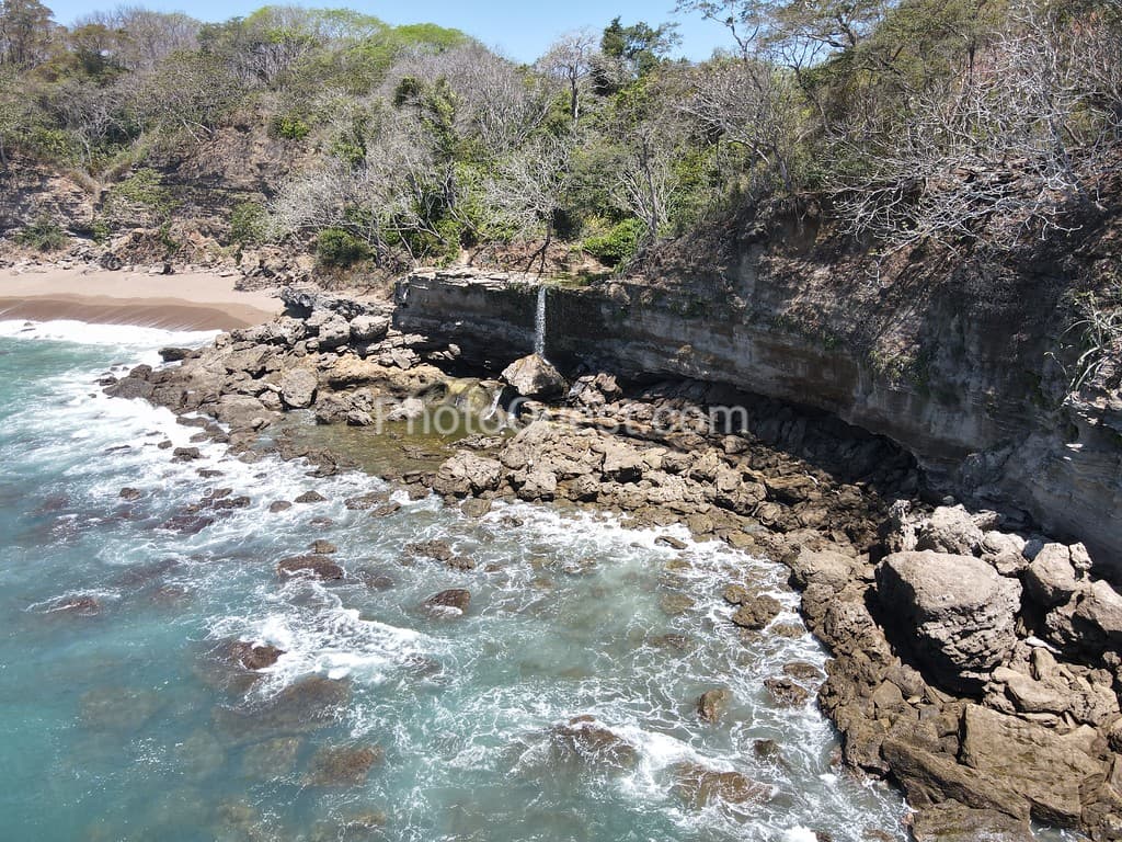 Lush Tropical Beach Paradise with blue water, great waves and rock formations in Montezuma Nicoya Peninsula Costa Rica