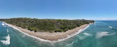 Lush Tropical Beach Paradise with blue water, great waves and rock formations in Montezuma Nicoya Peninsula Costa Rica