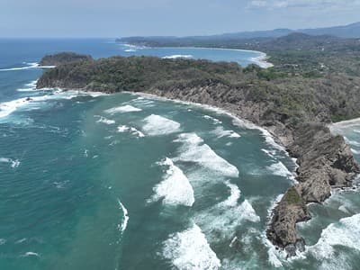 Samara Beach, Costa Rica: Turquoise waters meet rugged cliffs