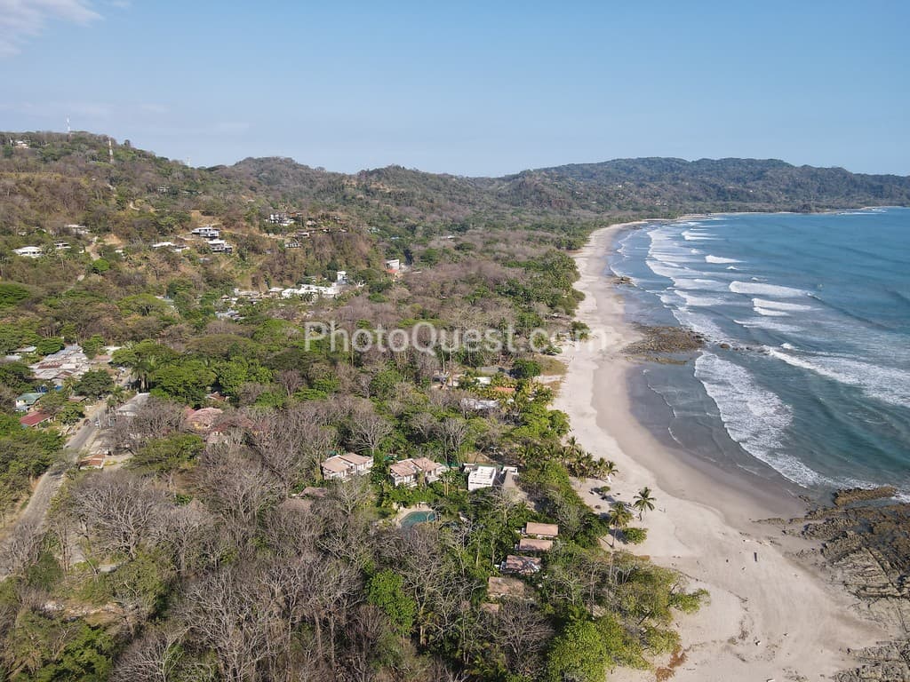 Lush Tropical Beach Paradise with blue water, great waves and rock formations in Malpais / Santa Teresa, Nicoya Peninsula Costa Rica