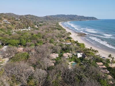 Lush Tropical Beach Paradise with blue water, great waves and rock formations in Malpais / Santa Teresa, Nicoya Peninsula Costa Rica